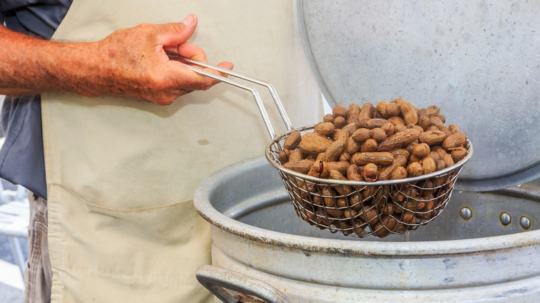 Hot boiled peanuts lifted from container
