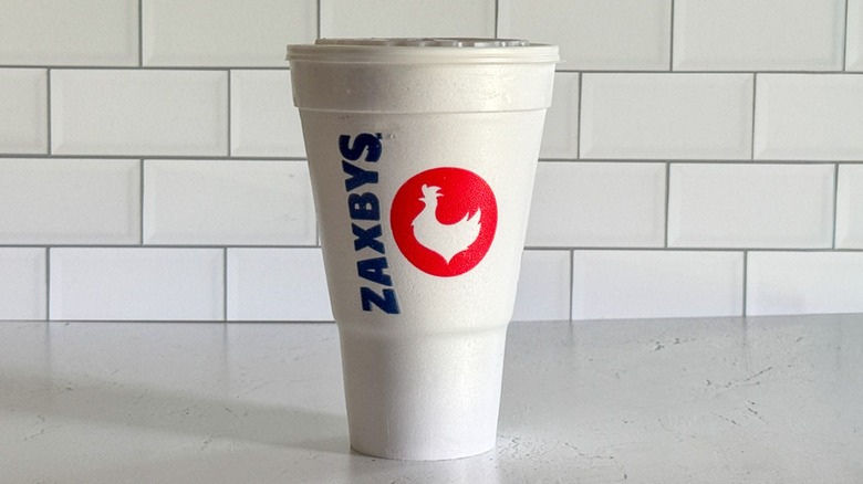 A 32-ounce medium foam Zaxby's cup containing sweet tea