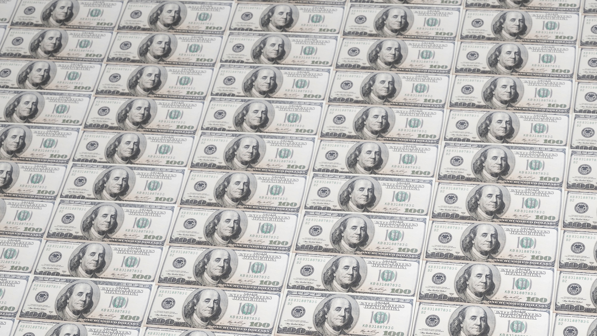 Hundred-dollar bills laid end to end and top to bottom.