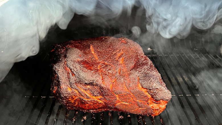 Pork butt cooking in a smoker