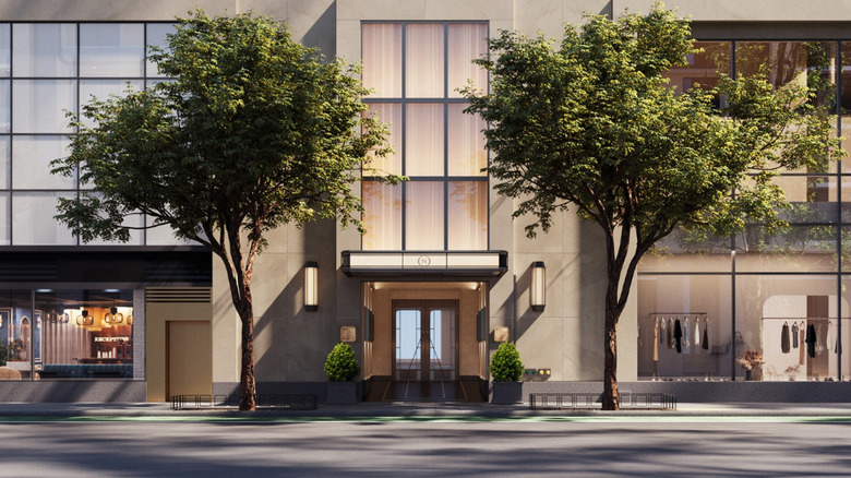 Approved rendering of the exterior of The Nell New York, with a modern facade and two trees next to the entrance