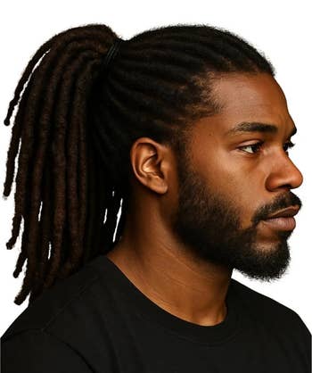 model with locs styled in a ponytail