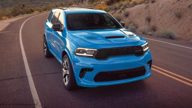 a blue Dodge Durango on a country road