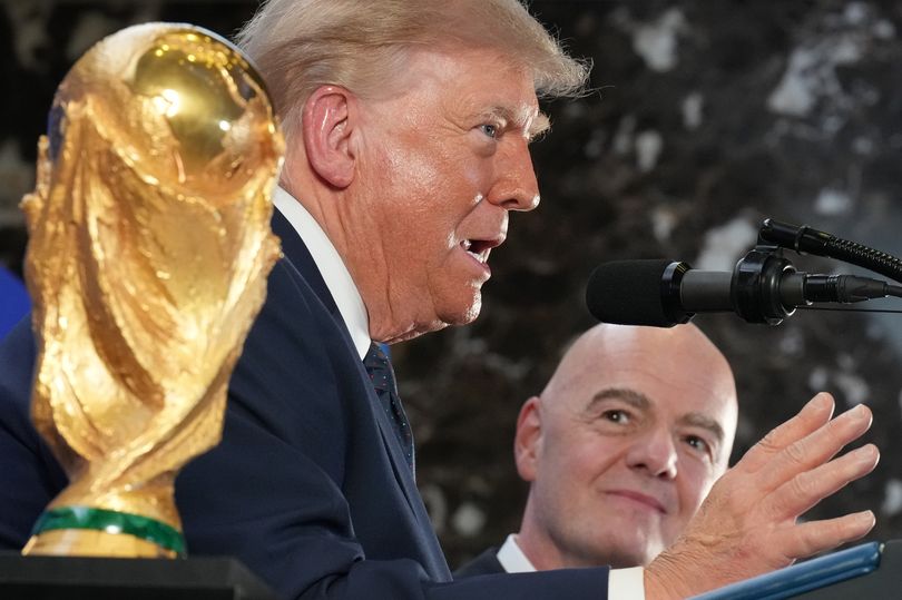 President Donald Trump speaks with his hand up as FIFA President Gianni Infantino listens