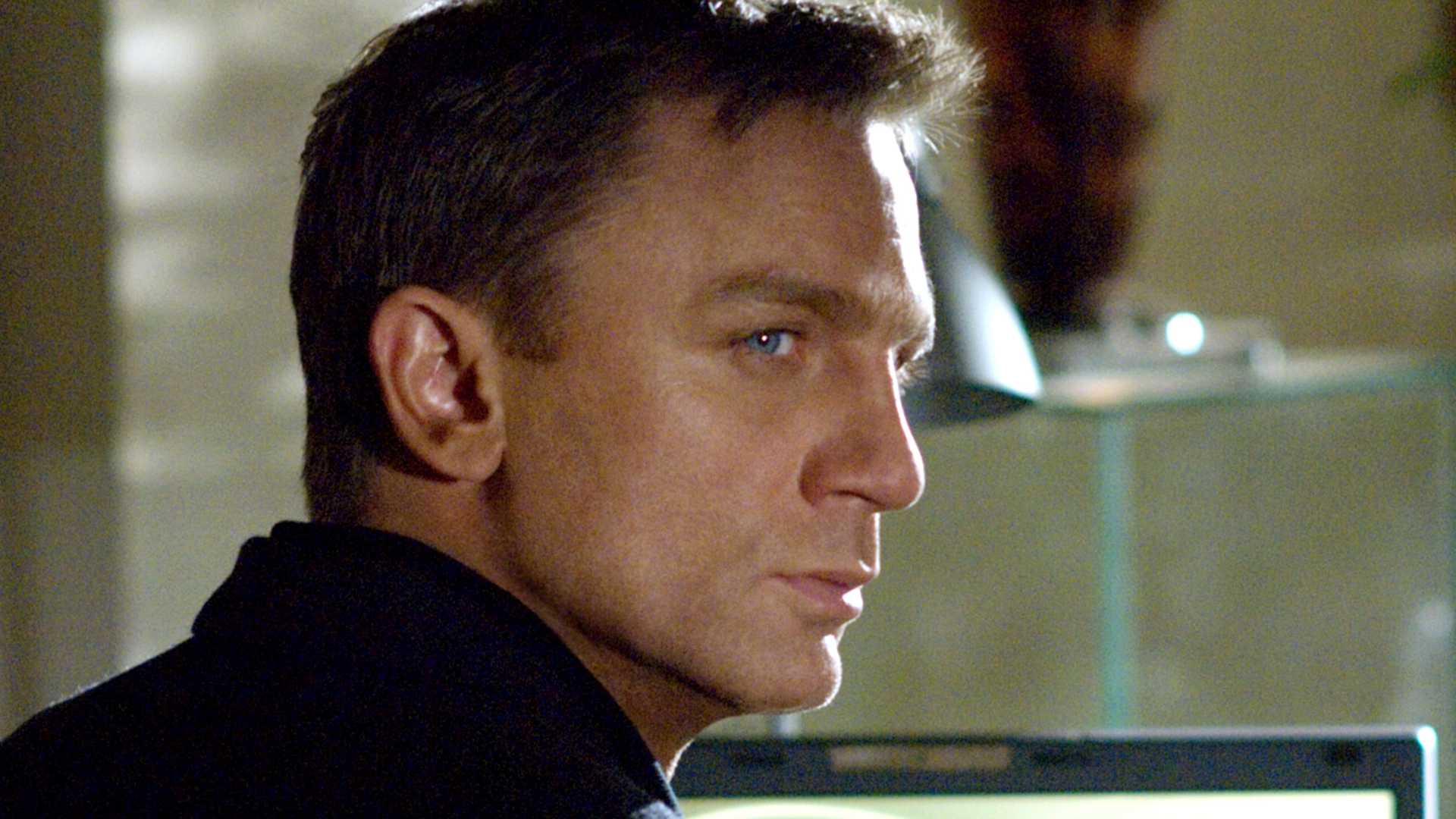 Daniel Craig looks over his shoulder as James Bond in Casino Royale