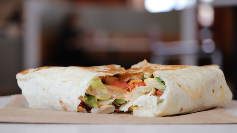 Close up of isolated open burrito on table at Taco Bell