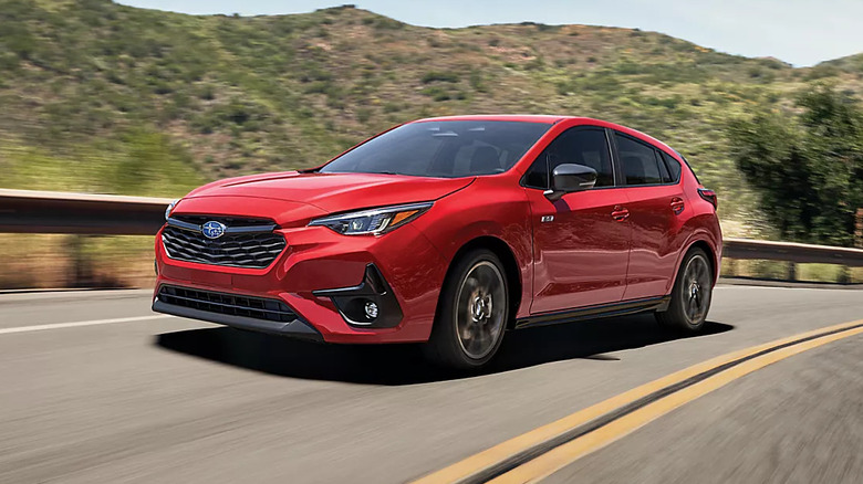 red 2026 Subaru Impreza RS driving down a desert highway