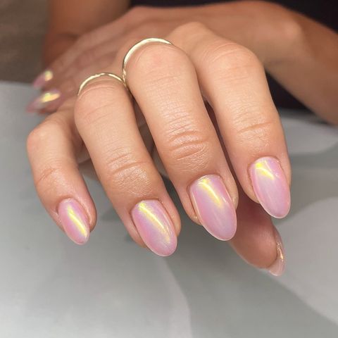 A hand with manicured nails featuring a glossy finish