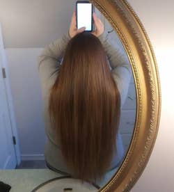 the same reviewer with their hair looking straight, sleek, and shiny