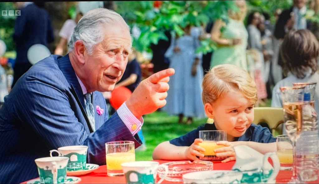 King Charles points out a curious sight for baby Prince George at a garden table