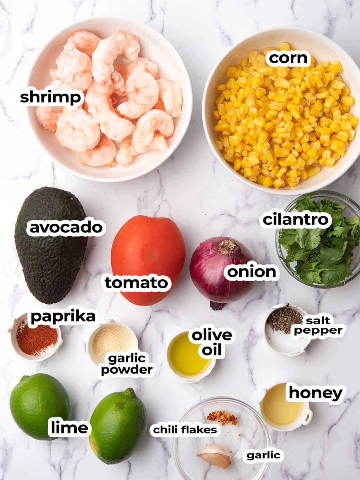 ingredients for the corn and shrimp sald arranged in the kitchen counter.