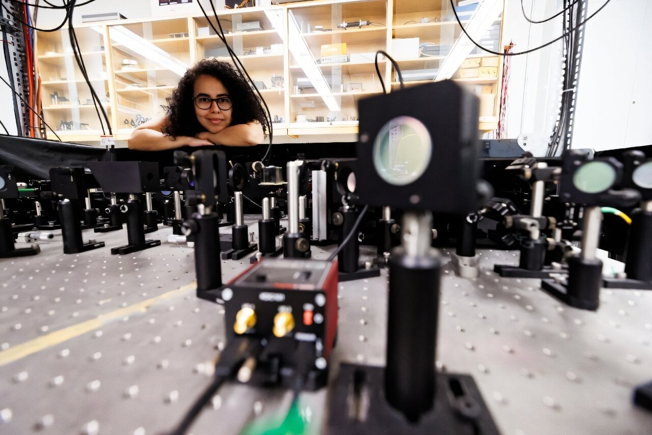 Experimental physicist Daniela Angulo poses with an apparatus in the physics lab at the University of Toronto. (CREDIT: University of Toronto)