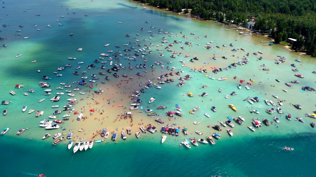 The famous Torch Lake Sand Bar, showing numerous boats docked.