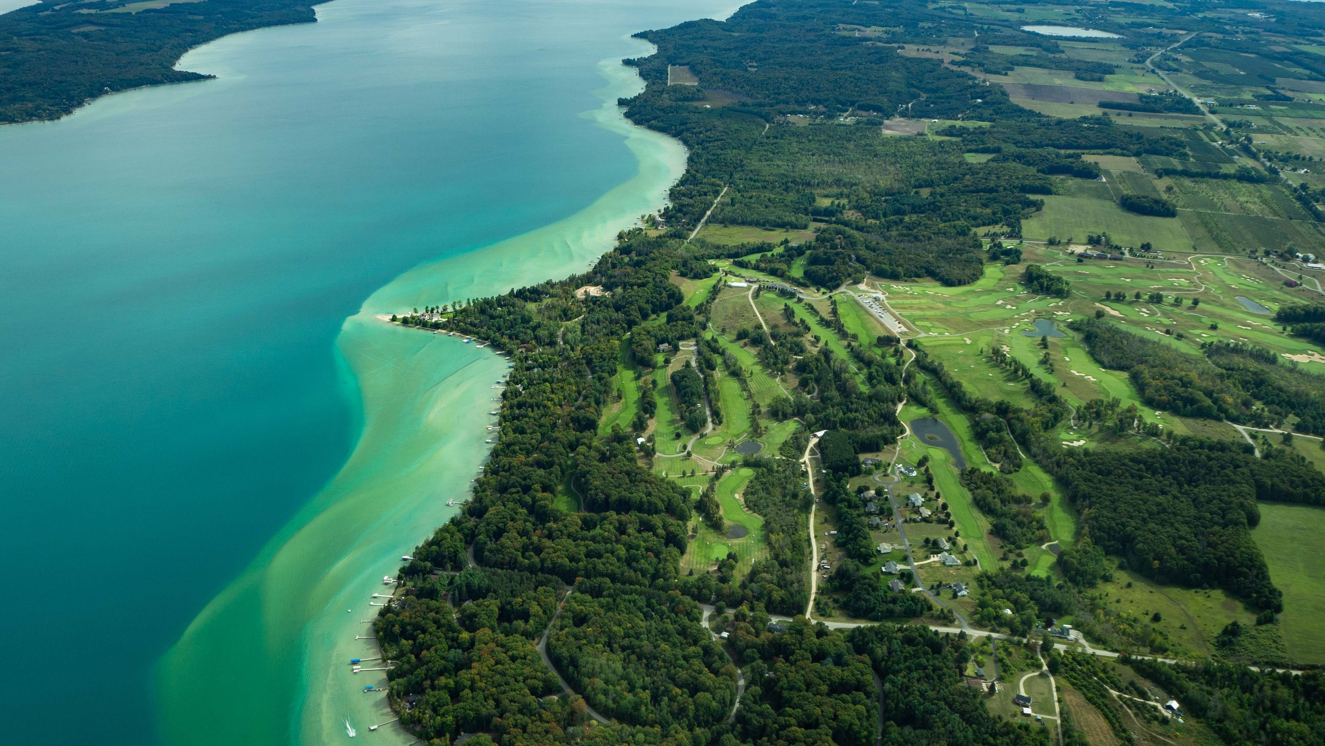 Aerial view of Torch Lake in Michigan, showing deep lake center and turquoise shores.