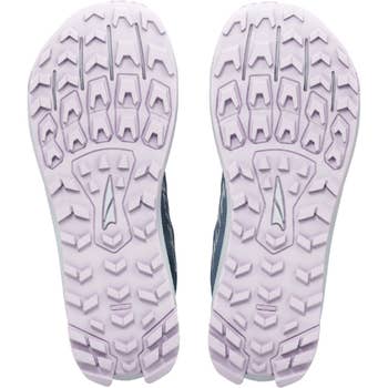 Sneaker soles featuring deep tread patterns designed for optimal traction, shown in a shopping article