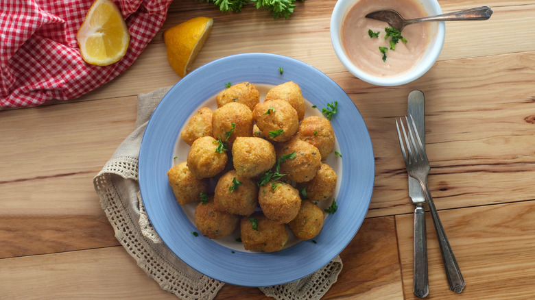 Hushpuppies with comeback dipping sauce on table
