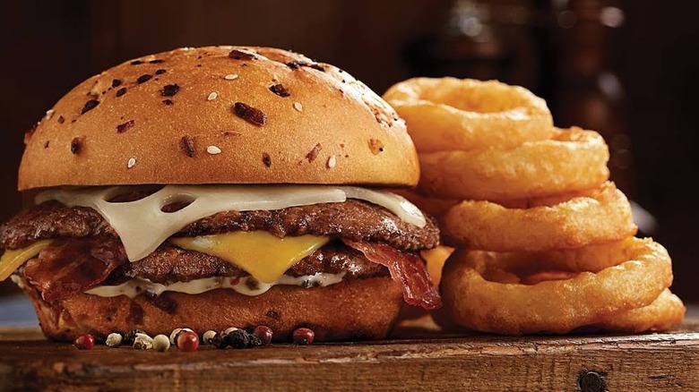 A product image of the Pepper Grinder Pub Burger and onion rings from Culver's