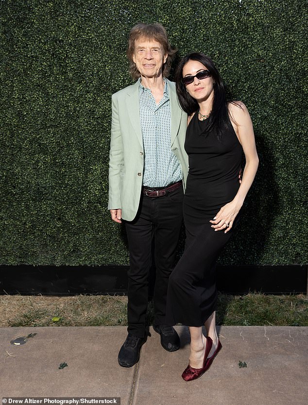 The musician kept it casual in a pale green blazer jacket, spotted shirt and black trousers. While Melanie opted for a simple figure-hugging black dress which she paired with red slip ons