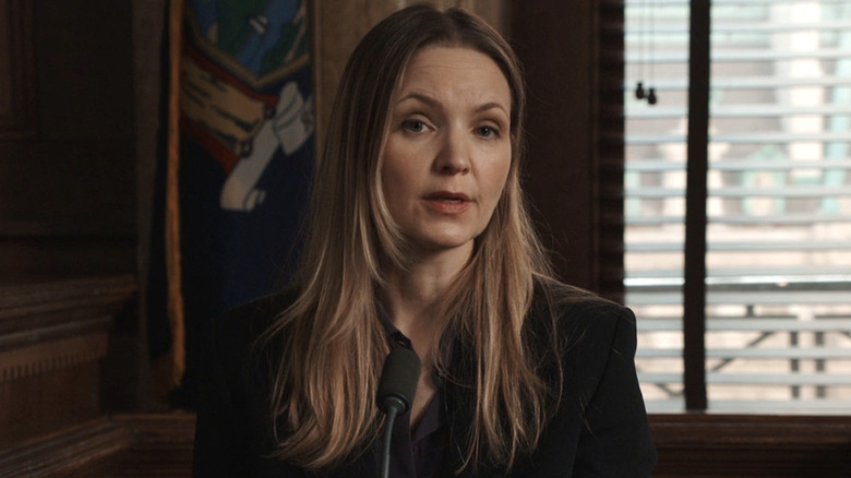 Shannah Sykes sitting in front of a microphone in a courtroom in Law & Order: SVU