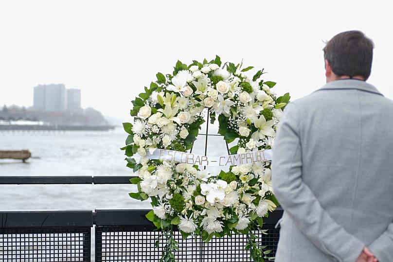 Joan Camprubí Montal, a relative of five of the victims of the Hudson River helicopter crash, stands in front of a memorial wreath in New York on Saturday, 12 April 2025.