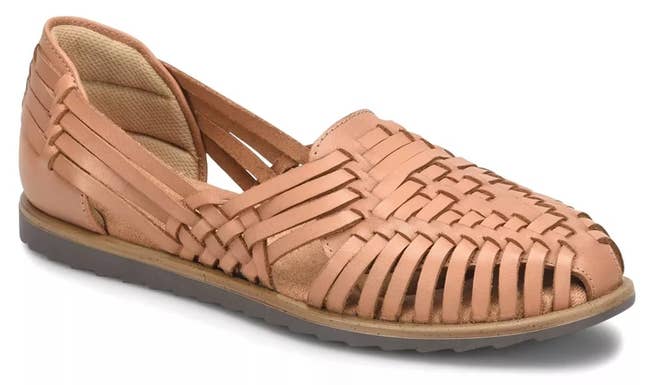 Brown woven leather huarache flat with a closed toe and open sides, suitable for casual summer wear