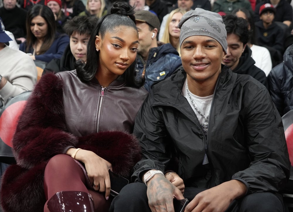Dec 29, 2025; Toronto, Ontario, CAN; Chicago Sky player Angel Reese (left) sits with her brother Julian Reese (right) of the Raptors 905 during a game between the Orlando Magic and Toronto Raptors at Scotiabank Arena. Mandatory Credit: John E. Sokolowski-Imagn Images