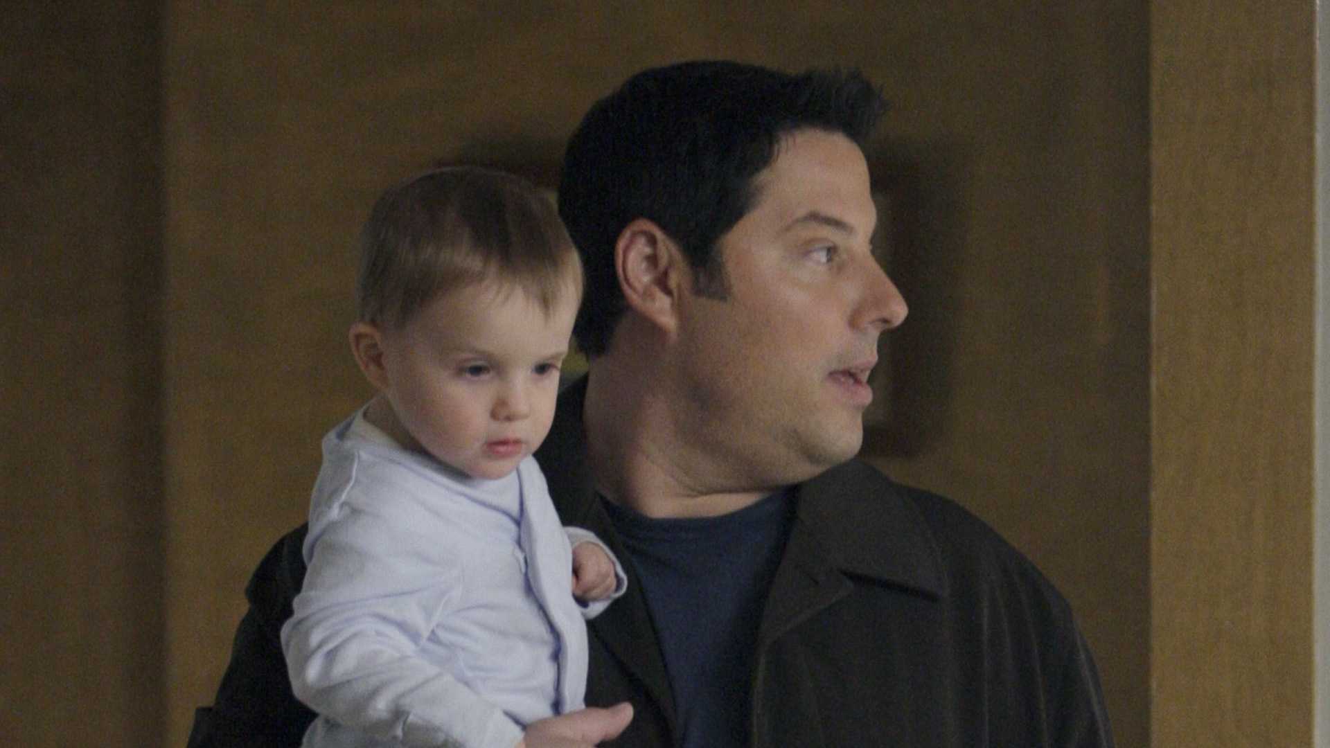 Matt Parkman holding his infant son