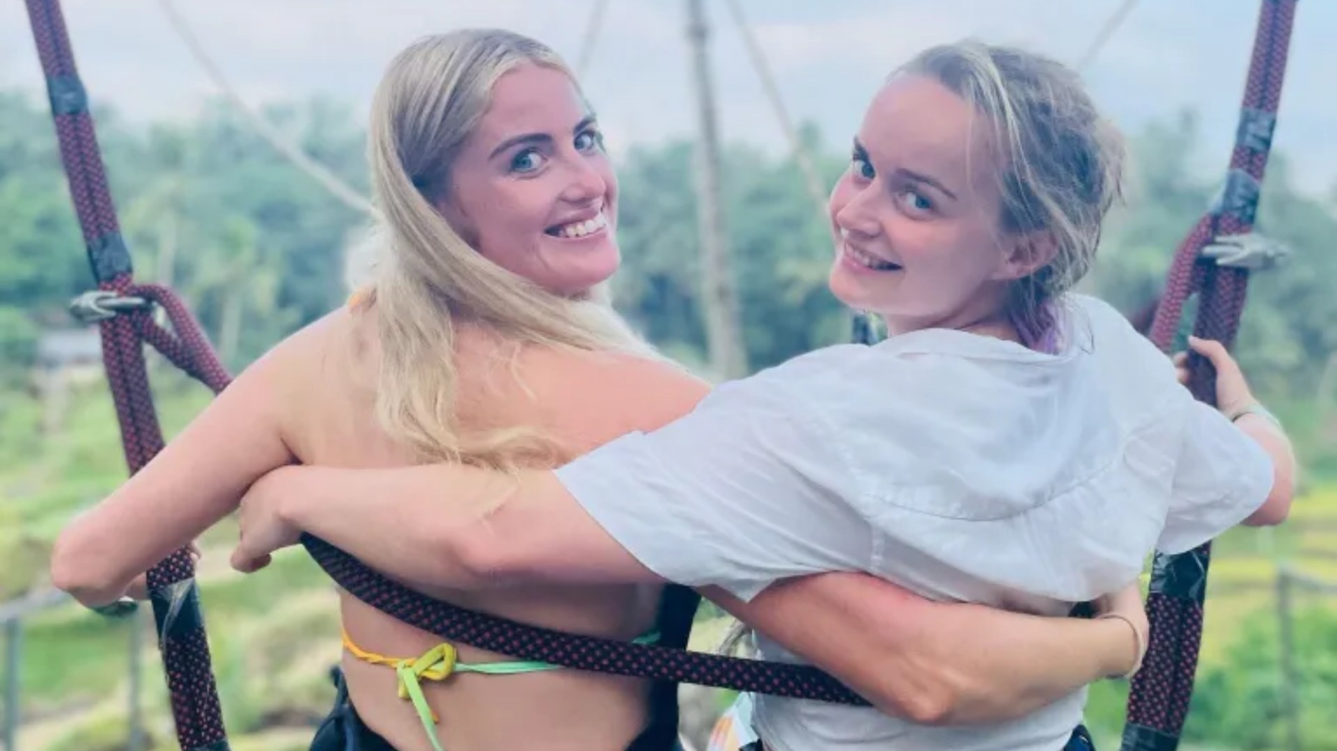 Simone White and Bethany Clarke on holiday on a swing