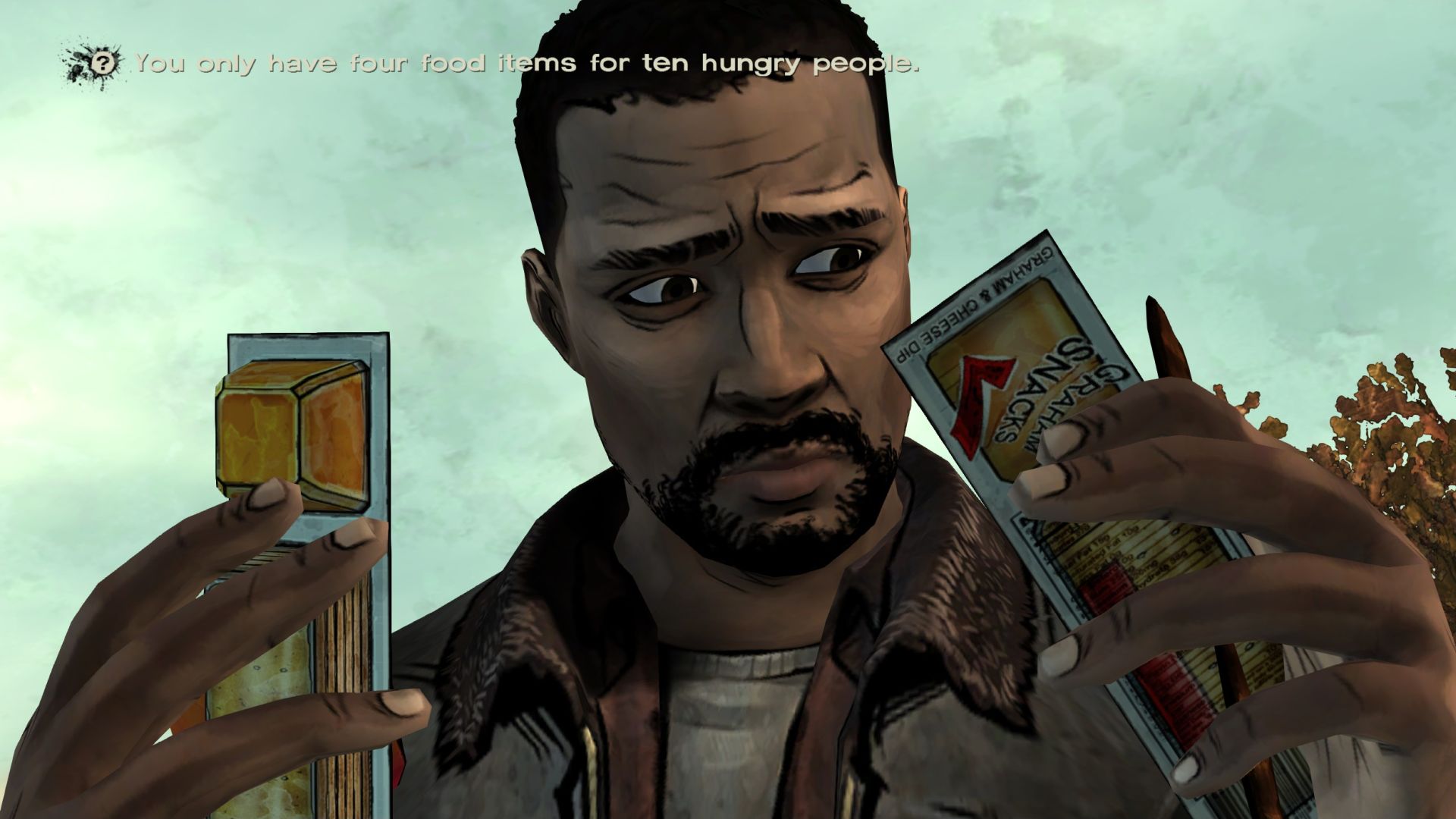Lee looks at a packet of cheese and crackers while agonizing over who to give them to