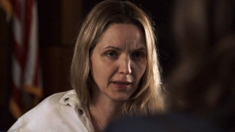 Delia Hackman in a white jacket sitting in a room facing Olivia Benson in Law & Order: SVU