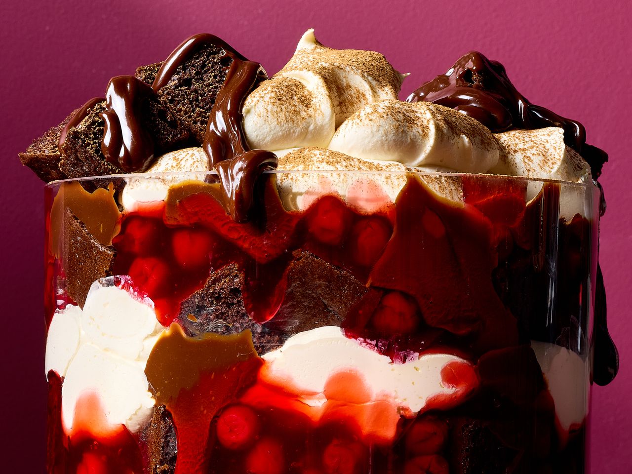 Layered dessert with cream cherries chocolate and cake chunks