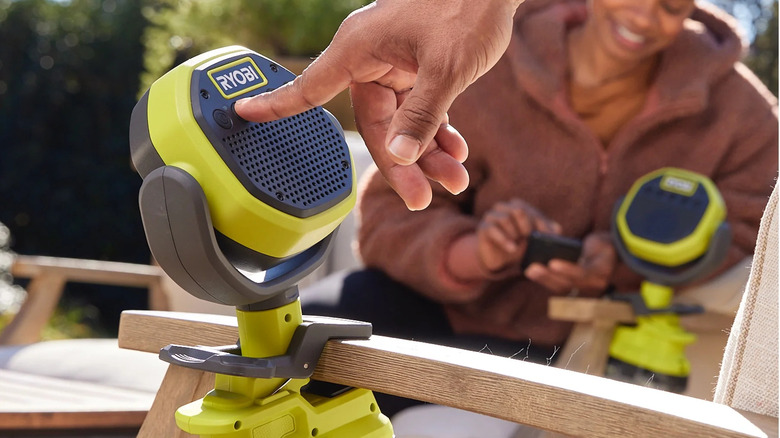 Ryobi clamp speaker attached to a chair arm.