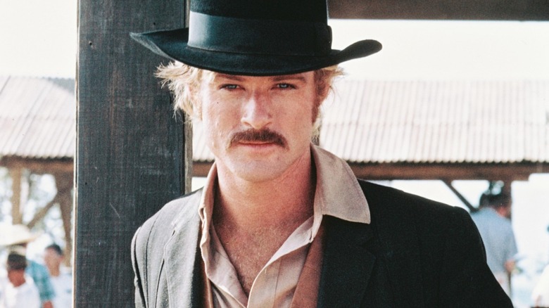 Robert Redford in a black cowboy hat and suit