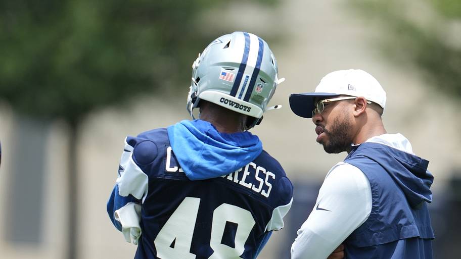 Dallas Cowboys defensive coordinator Christian Parker speaks with cornerback Zion Childress (48) during practice.