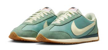 Retro-style sneakers with suede panels and a prominent swoosh logo on the side, featuring a gum sole