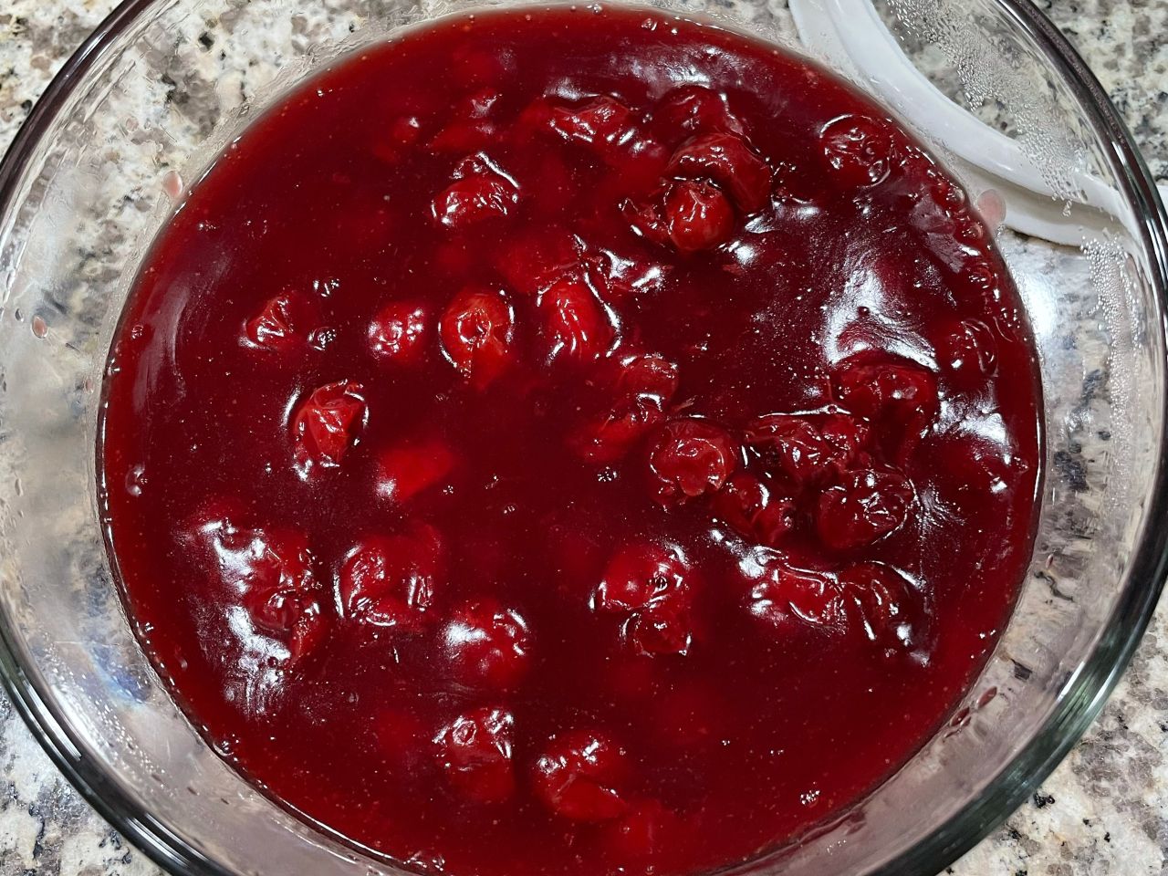 Close-up of tart cherry compote in a glass bowl