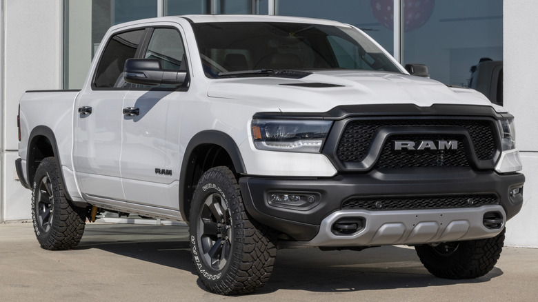 A white 2023 RAM 1500 parked outside of a dealership.