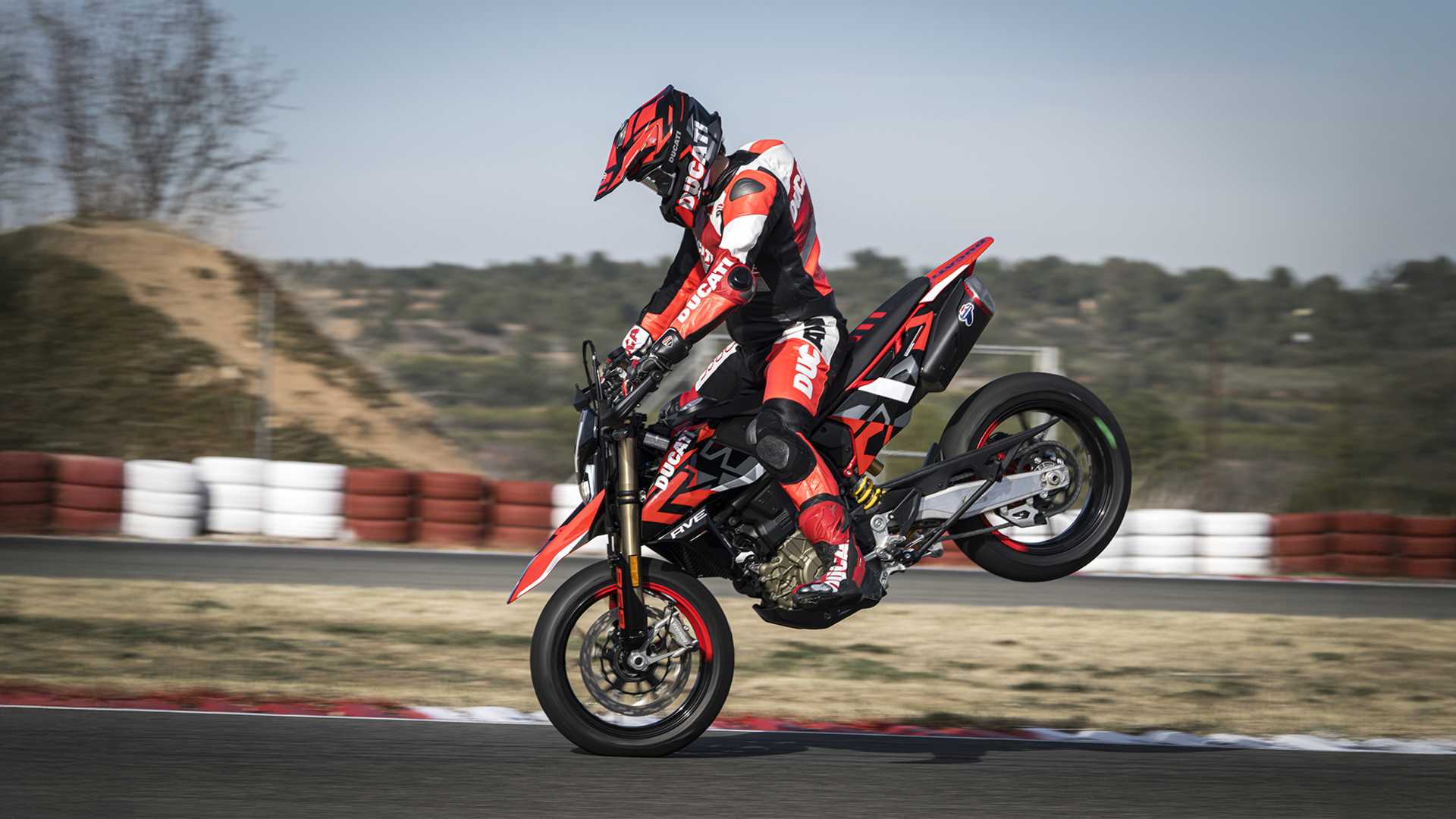 An action shot of a Ducati Hypermotard 698 mid stoppie