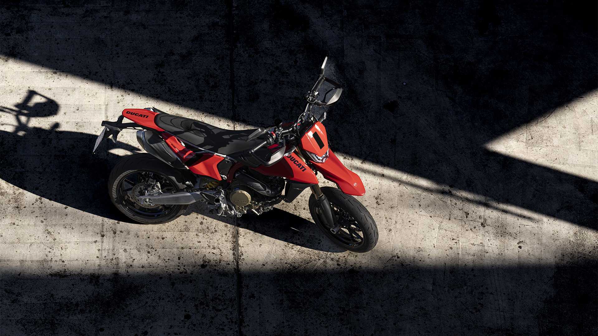 A dramatic top-down shot of the Ducati Hypermotard 698