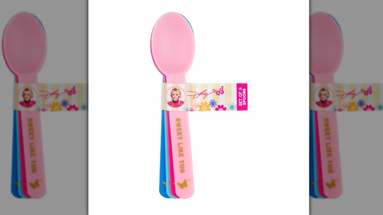 Set of four pink and blue spoons wrapped in a small label with Dolly Parton's headshot and signature