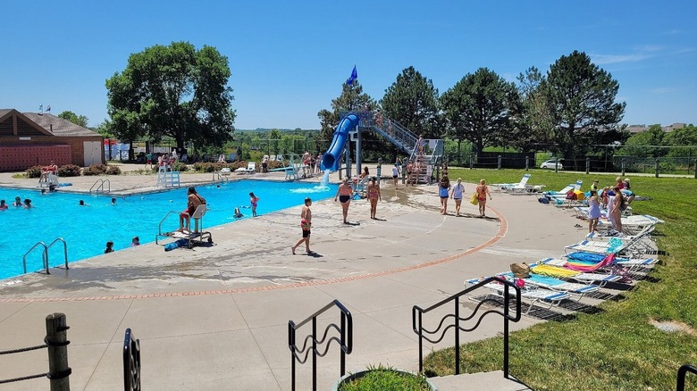 People walk around a swimming pool at Mahoney State Park on a sunny day in Nebraska