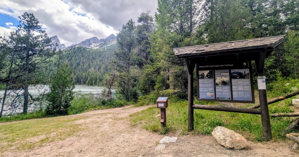 A sign stands next to the String Lake/Leigh Lake Trailhead in Grand Teton National Park.