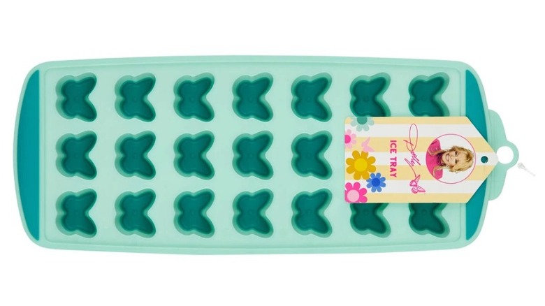 Horizontal view of silicone butterfly-shaped ice cube tray with a label with Dolly Parton's headshot and signature