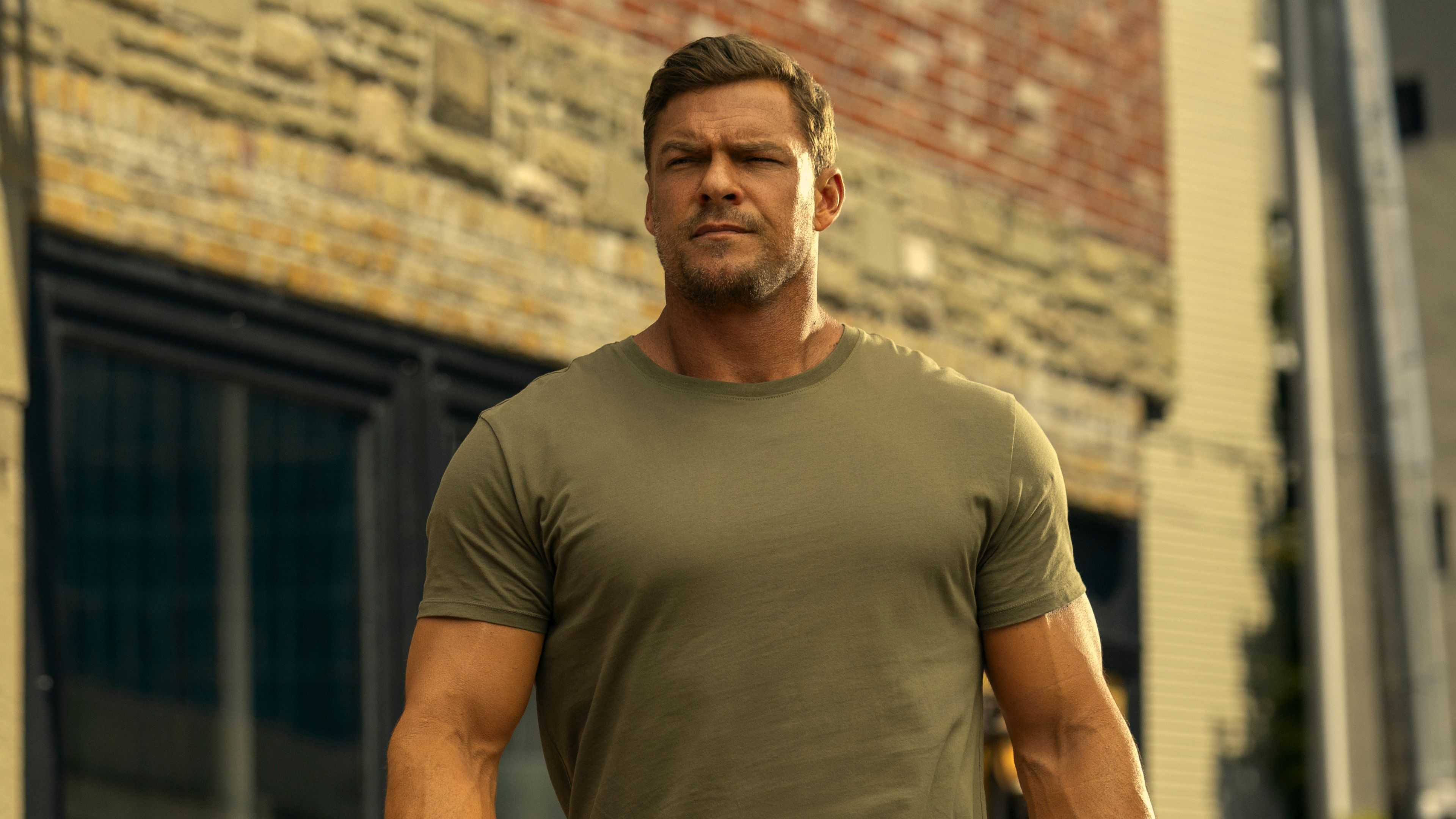 Jack Reacher looking tall against a building