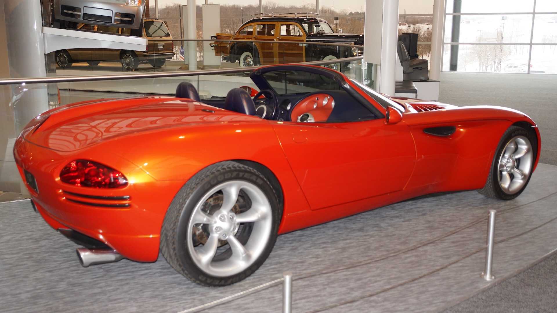 The rear end of a copper colored dodge concept roadster