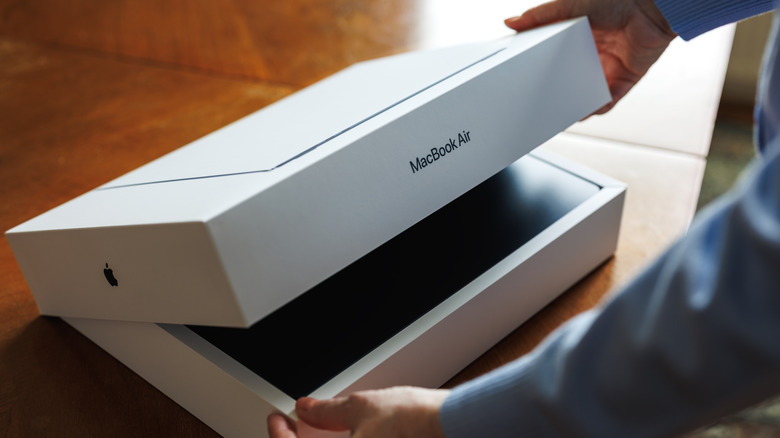 Person unboxing a MacBook Air
