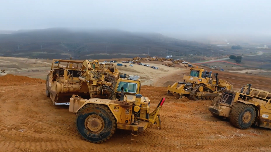 Extreme heavy equipment working together on a giant construction site