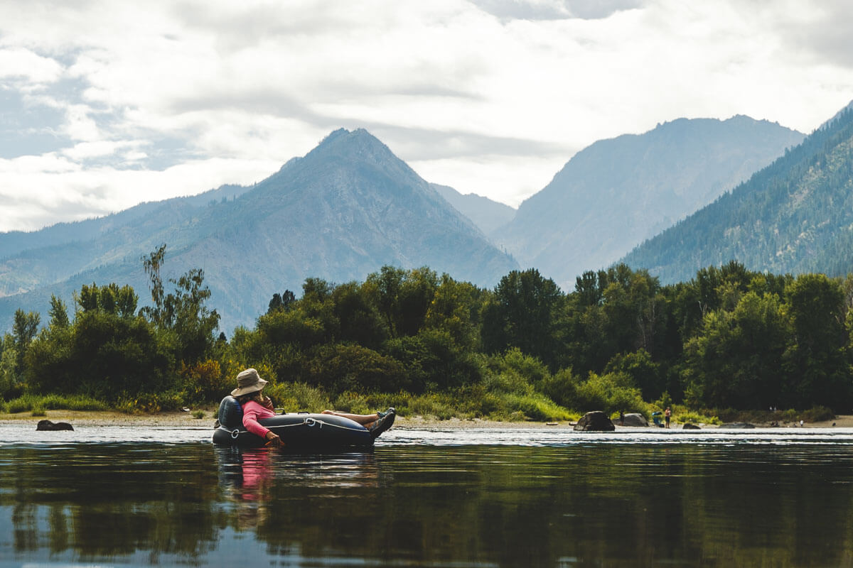 A person floating on an inner tube down the Wenatchee River near Leavenworth, Washington.