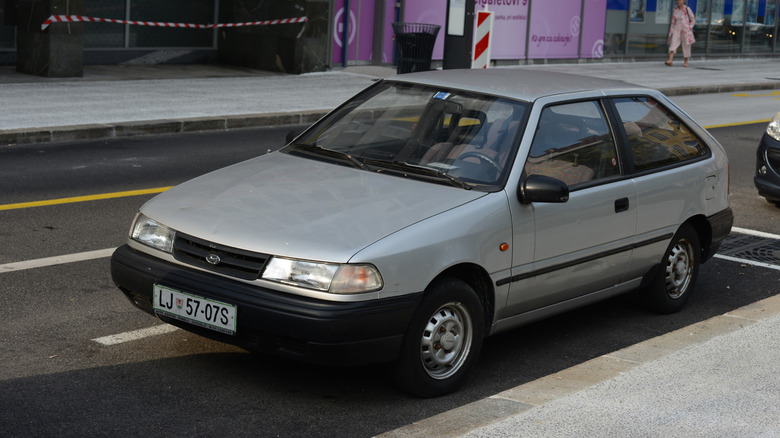 Gray Hyundai Excel parked on a city street