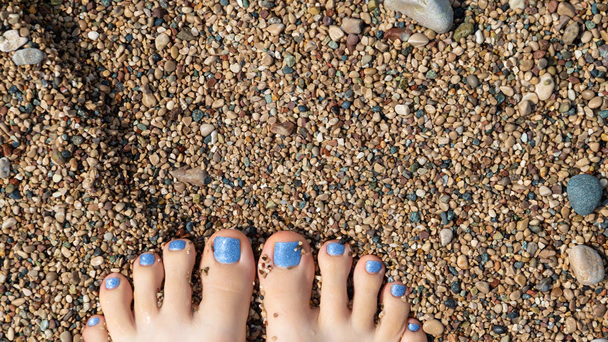 beautiful-female-feet-with-blue-glitter-pedicure
